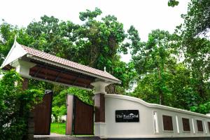 AthirappillyAthirappilly Rainland Resort的白色的建筑,有门,上面有标志