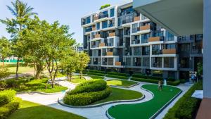 an apartment building with a garden and a pathway at Laguna Skypark in Phuket