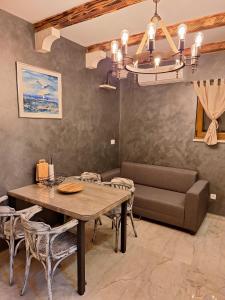 a dining room with a table and a couch at Holiday Home M & M in Bibinje