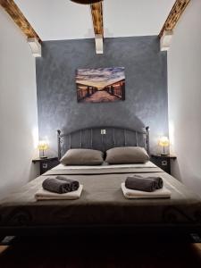 a bedroom with a bed with two towels on it at Holiday Home M & M in Bibinje