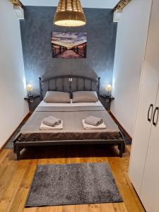 a bedroom with a bed with two towels on it at Holiday Home M & M in Bibinje +16 photos