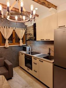 a kitchen with a sink and a refrigerator at Holiday Home M & M in Bibinje