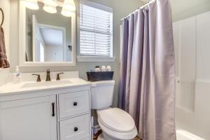 a bathroom with a sink and a toilet and a mirror at Charming Hinesville Home Less Than 6 Mi to Fort Stewart in Hinesville +18 photos