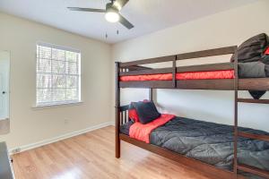 a bedroom with two bunk beds and a ceiling fan at Charming Hinesville Home Less Than 6 Mi to Fort Stewart in Hinesville