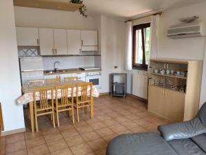 een keuken en eetkamer met een tafel en stoelen bij Appartamento in villa nel bosco in Arrone