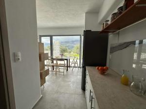 a kitchen with a counter and a table with chairs at Rouvas Villas in Apomarmá