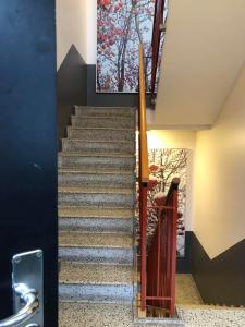 a staircase in a house with a painting on the wall at Holte lejlighed in Holte