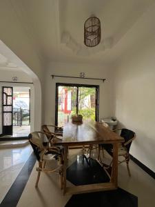 a dining room with a wooden table and chairs at Bomani House in Arusha
