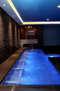 a swimming pool in a hotel with blue water at Best Western Plus Paradise Hotel Dilijan in Dilijan