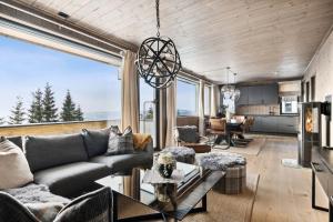 a living room with a couch and a table at Hafjell Front 8pers, Ski in/out. Downhill Bike in Hafjell