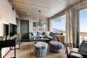 a living room with a couch and a table at Hafjell Front 8pers, Ski in/out. Downhill Bike in Hafjell