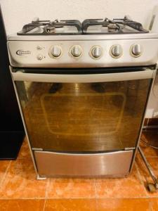 a white stove top oven sitting in a kitchen at 2 de Mayo Miraflores Private Rooms in Lima