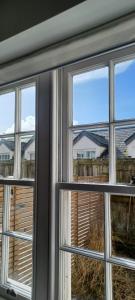 a window with views of a yard at The Court Cottage 2 bedroom in Exeter