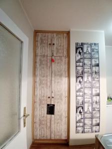 a wooden door in the corner of a room at Apartman A-1 in Zaječar +3 photos