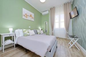 a small bedroom with a bed and a television at PR APARTMENT - FIUMICINO ROME AIRPORT 9 Min - in Fiumicino
