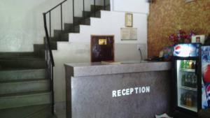 a restaurant with a reception counter and stairs at GRG Hotel Grace Agra in Agra