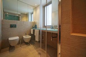 a bathroom with a toilet and a sink and a mirror at The charming house in Taormina +48 photos