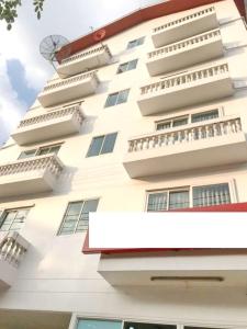 a white building with balconies on it at Wellness Mansion Hotel in Dusit