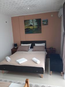 a bedroom with a bed with two towels on it at Becic Apartments in Ulcinj