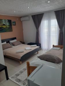 a bedroom with two beds and a window at Becic Apartments in Ulcinj