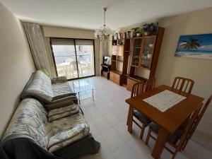 a living room with a couch and a table at Playamar Altamar Apartments in Alcossebre