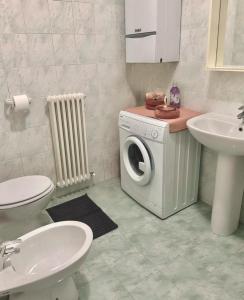 a bathroom with a washing machine and a sink at Apartment Menaggino in Menaggio