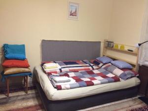 a bedroom with a bed with a blanket on it at Casa Mamma in Budapest