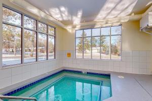 a swimming pool in a room with windows at Delton Grand Resort in Wisconsin Dells