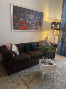 a living room with a brown couch and a table at Fashion Loft Luxury Milano in Milan