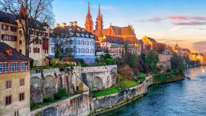 an old bridge over a river in a city at Cozy Flat in the Center of Kleinbasel in Basel