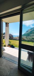 an open glass door with a view of a field at Oasi love & relax in Maratea