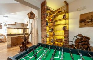 a living room with a pool table in front of a wall at G&S Rustic House in San Pancrazio Salentino