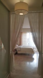 a bedroom with a bed and a window with curtains at Apartments on Kirova in Dnipro