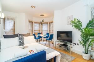 a living room with a couch and a tv at Heart of London's West End / Pro Host in London