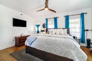 a bedroom with a large bed and a flat screen tv at Agustin Inn - Saint Augustine - Adults Only in Saint Augustine