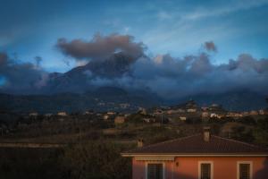 a house with a mountain in the background at La Perla Nascosta in Belvedere Marittimo
