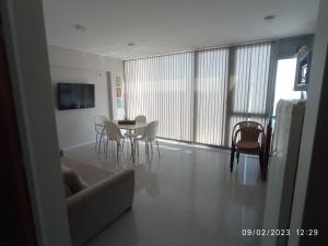a living room with a table and chairs and a window at DEPARTAMENTO PUERTO MADRYN in Puerto Madryn