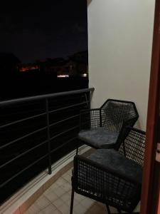 a chair sitting on top of a balcony at night at Outer homes in Nairobi