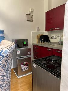 a kitchen with a stove top oven next to a bed at Outer homes in Nairobi