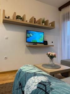 a living room with a tv on the wall at Zgonjanin Wellness&Spa in Zlatibor