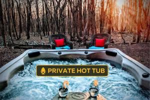 a hot tub in the middle of a forest at Chestnut Tree Lodge - Modern Wooded Escape in Jim Thorpe