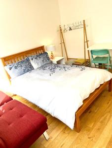 a bedroom with a large bed and a red chair at Waterloo Central London in London