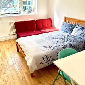 a bedroom with a bed and a red couch at Waterloo Central London in London