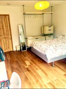 a bedroom with a bed and a mirror and wooden floors at Waterloo Central London in London
