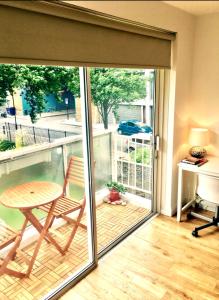 a sliding glass door with a table and a desk at Waterloo Central London in London