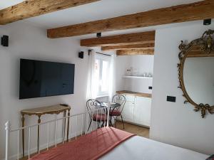a bedroom with a bed and a tv on the wall at M&R Apartments II in Koper