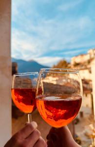 two people holding up glasses of wine at La casa del fumetto in Castel di Sangro