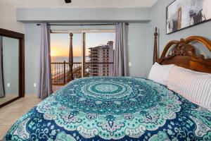 a bedroom with a bed with a view of the ocean at Sonoran SKY #910 in Puerto Peñasco