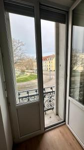 an open door to a balcony with a bench outside at Appartement F5 proche centre ville in Mulhouse