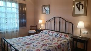 a bedroom with a bed and two lamps and a window at La Xana Ribadesella in Ribadesella